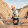 Smiley builder using a hammer at a construction site