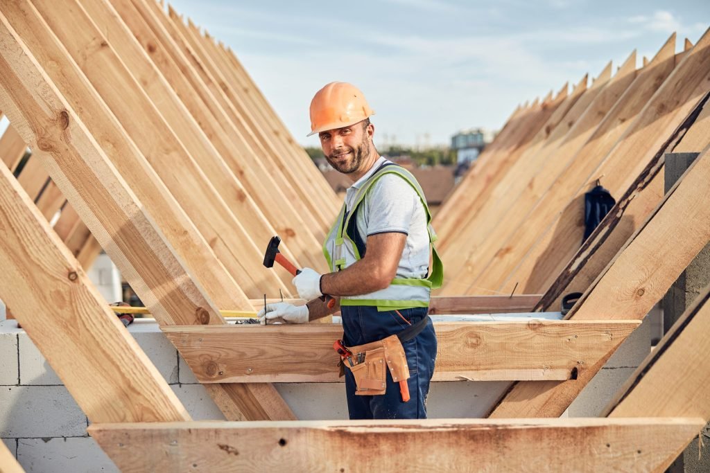 Smiley builder using a hammer at a construction site